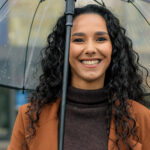 Woman smiling in the rain in Dickson and [test_shortcode]